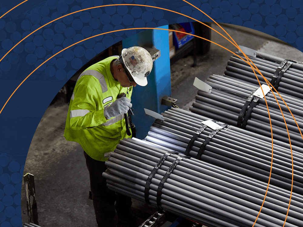 man inspecting charter steel manufactured steel rods